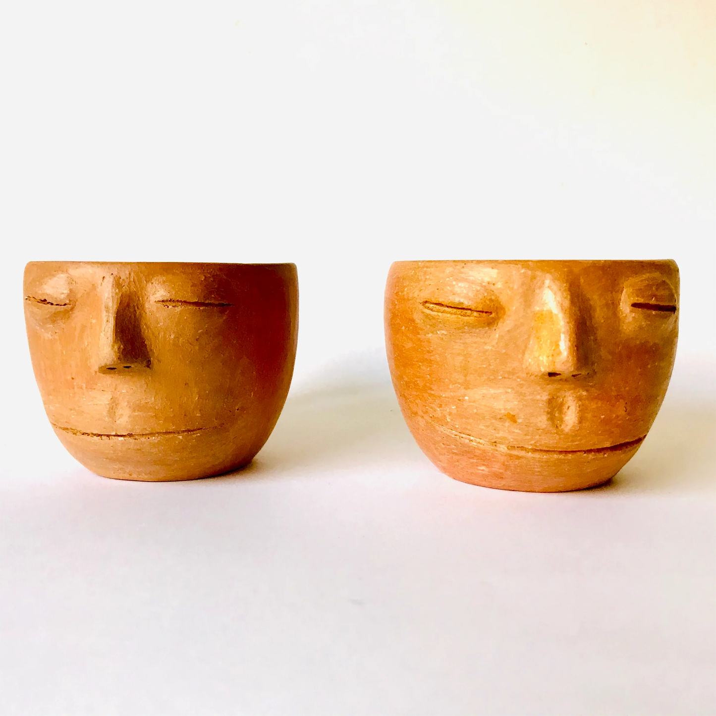 Red Clay Cup with a Face